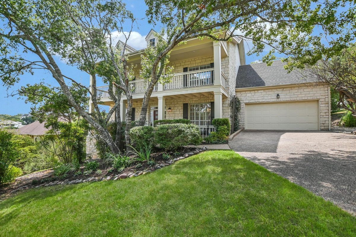 5901 Round Table Cove, Austin, TX — front exterior with porches on both stories